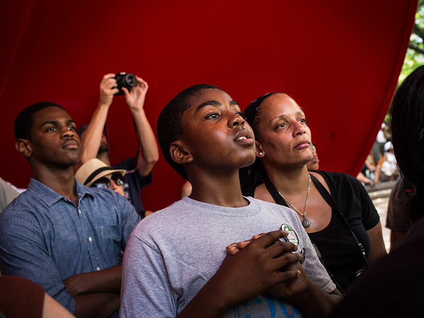 A boy cranes his head to hear a speaker while attending a rally in support of Trayvon Martin, organized by the Reverand Al Sharpton, in response to the non-guilty verdict for George Zimmerman on July 20, 2013 in New York City. (Photo by Andrew Burton...