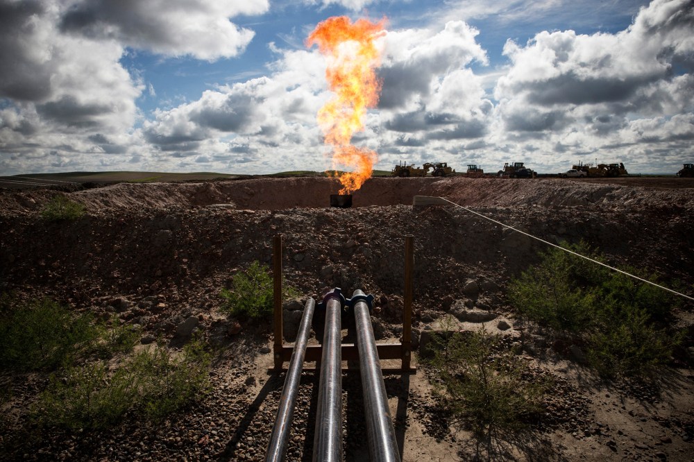 A gas flare is seen at an oil well site on July 26, 2013 outside Williston, N.D.