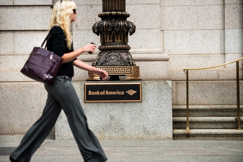 A woman walks past a Bank of America in Washington, DC., Aug. 7, 2013.