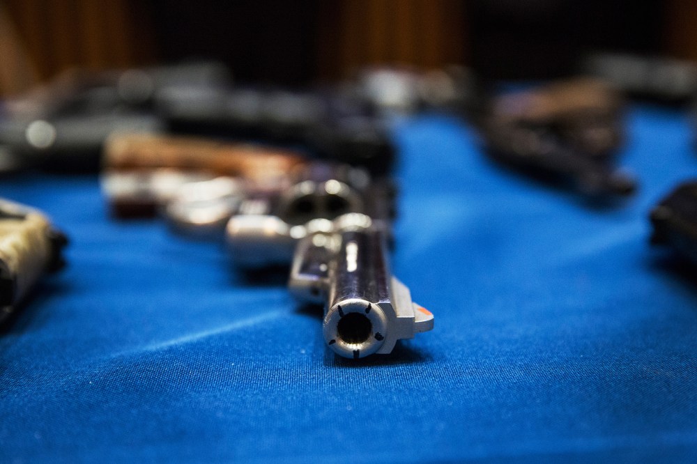 Guns seized by the New York Police Department are displayed during a press conference, August 19, 2013.
