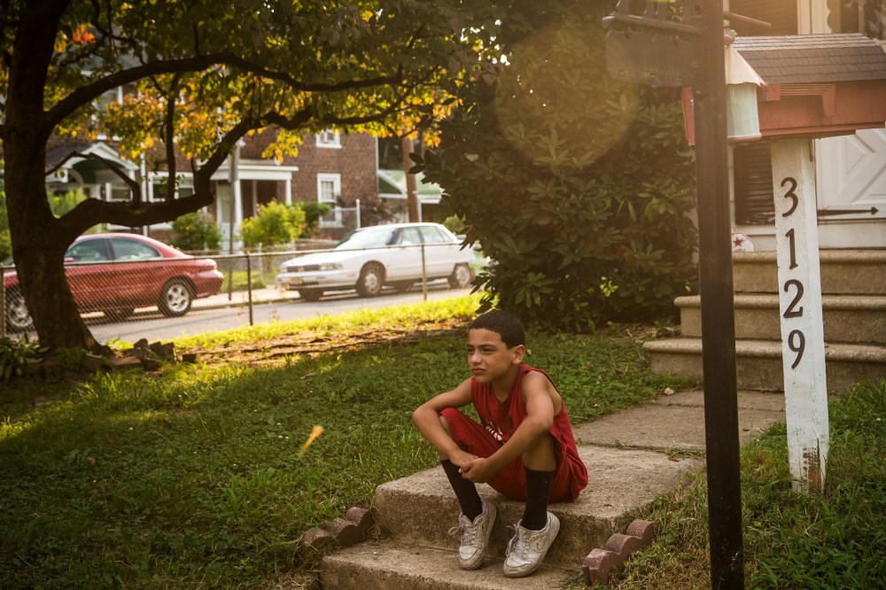 A boy sits on his front steps on August 20, 2013 in the Fairview neighborhood of Camden, New Jersey.