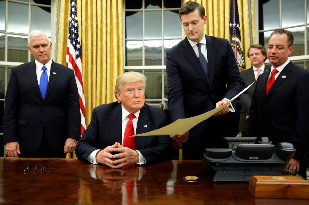 Image: FILE PHOTO: Porter hands document to Trump during signing ceremony in the Oval Office in Washington