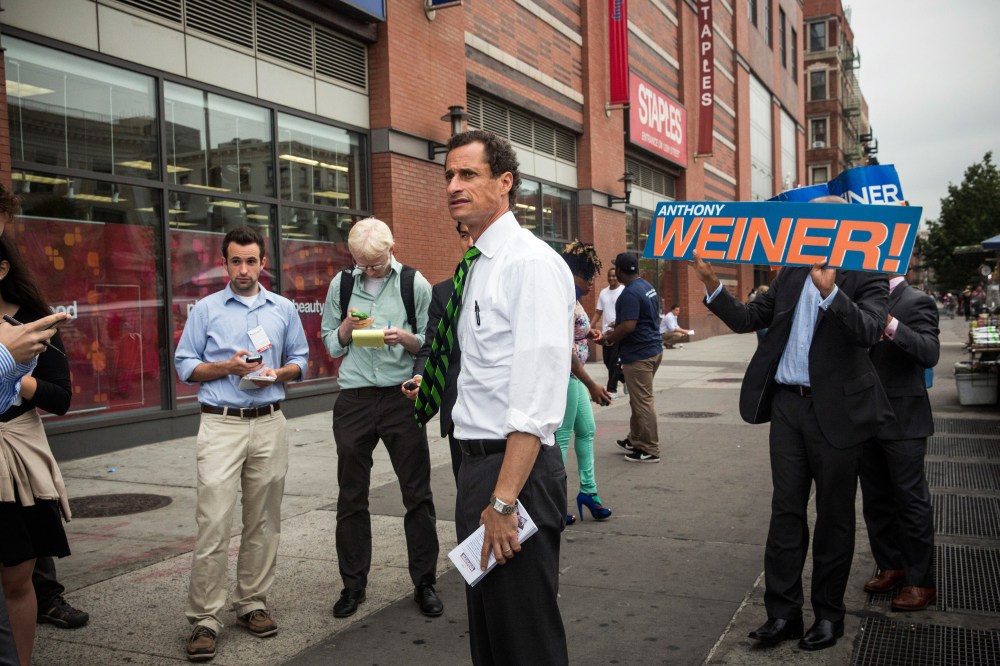 New York City mayoral hopeful Anthony Weiner meets with people on a street corner In Harlem on September 10, 2013 in New York City.