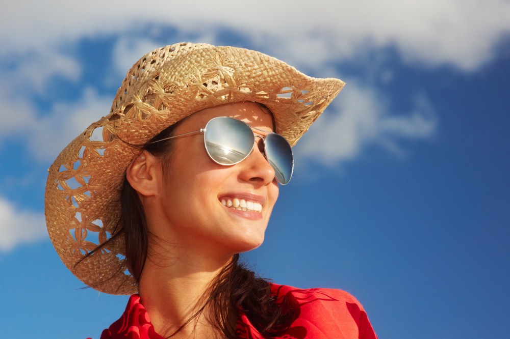 Image: Trendy young woman over the blue sky background