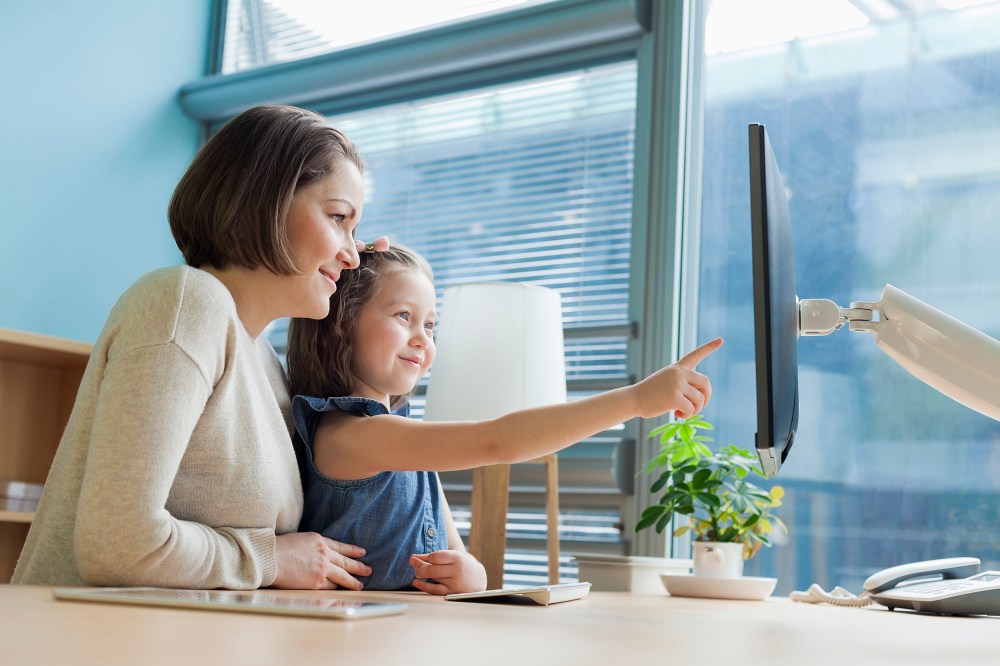 Image: Mother and daughter looking at work desk computer