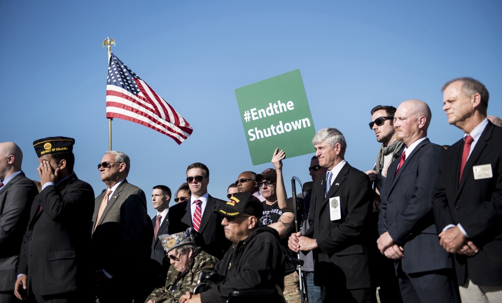 Activists listen to speakers during a rally at the World War II Memorial