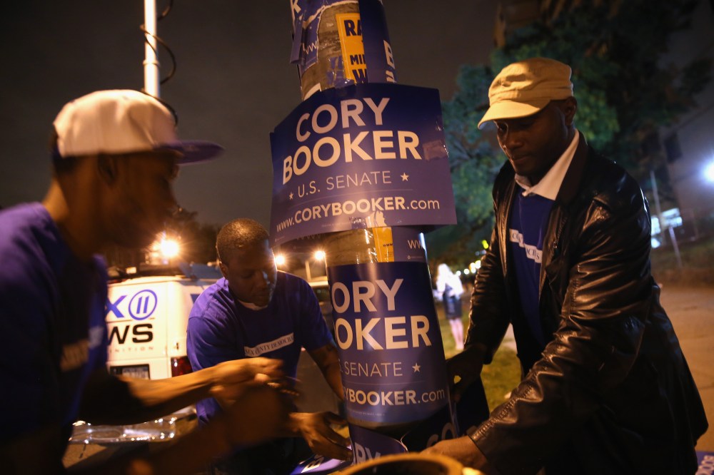 Campaign workers for Newark Mayor Cory Booker put up signs outside a polling station  for a special U.S. Senate election on October 16, 2013 in Newark, New Jersey.