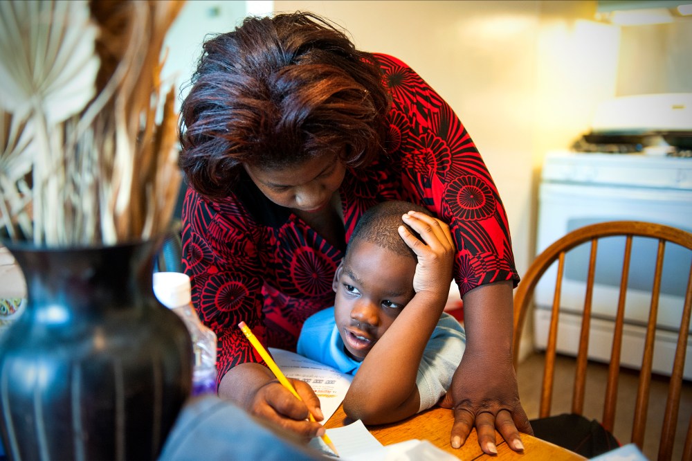 Monique Henderson helps her son, Geramiah, 8, with his homework after school in Camp Springs, MD, Oct. 15, 2013.