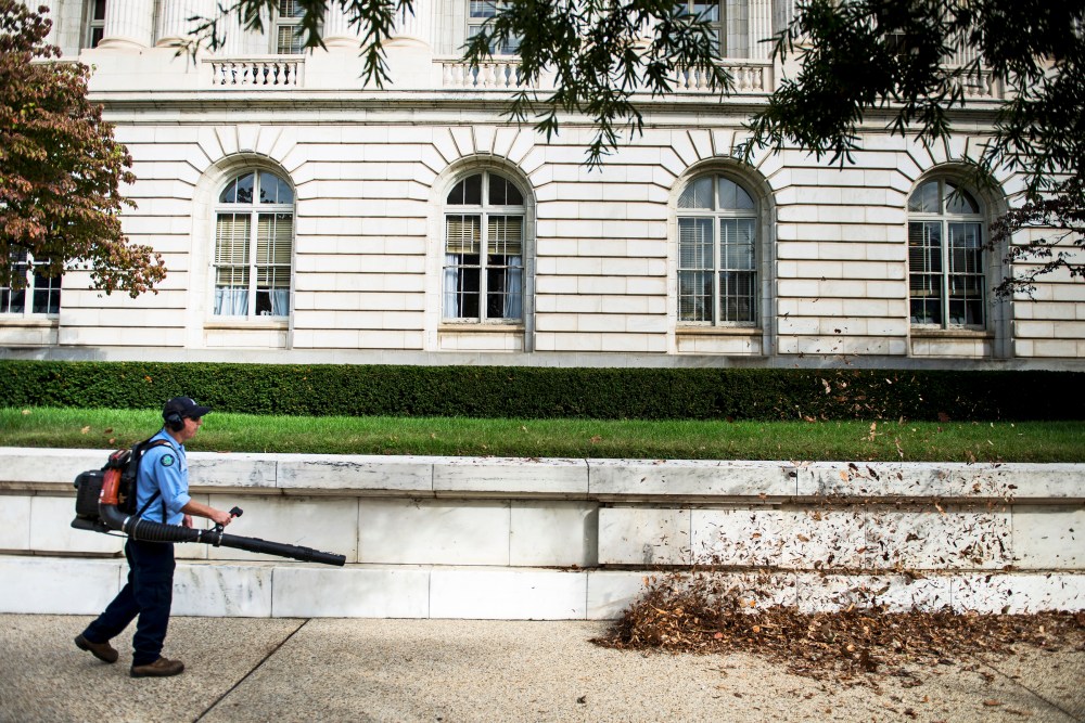 A worker cleans leaves from the Russell Senate Office Building on Capitol Hill October 17, 2013 in Washington, DC.