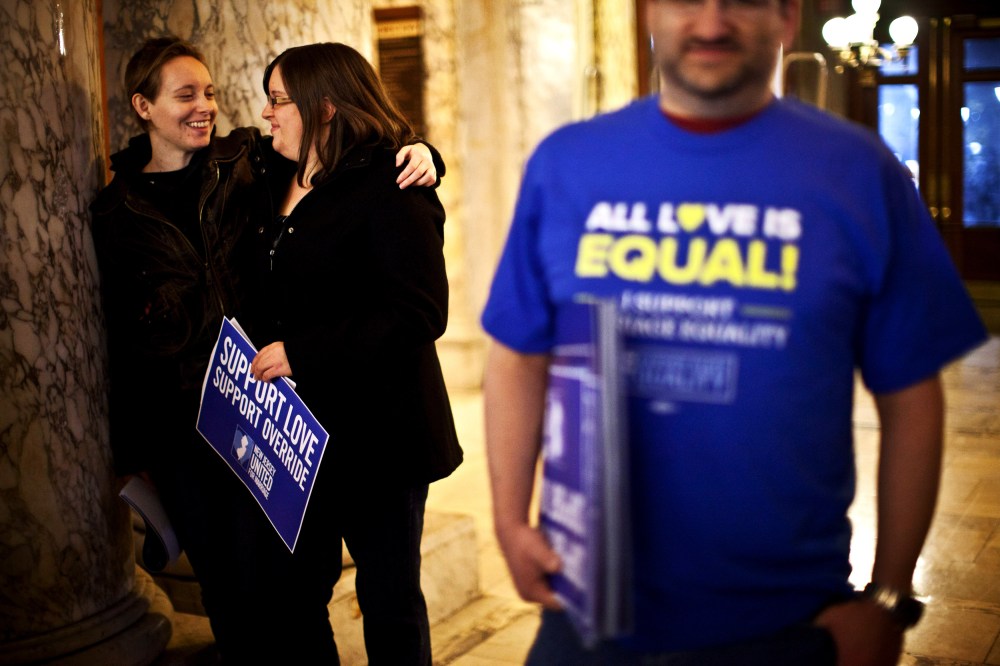 Lauren and Katelynn hug each other as they attend the first massive gay wedding ceremonies at City Hall in the early morning hours of October 21, 2013 in Newark, New Jersey.