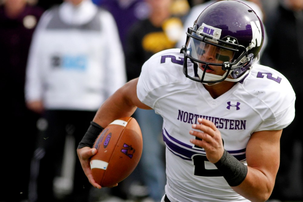 Quarterback Kain Colter of the Northwestern Wildcats plays against the Iowa Hawkeyes on Oct. 26, 2013 at Kinnick Stadium in Iowa City, Iowa.