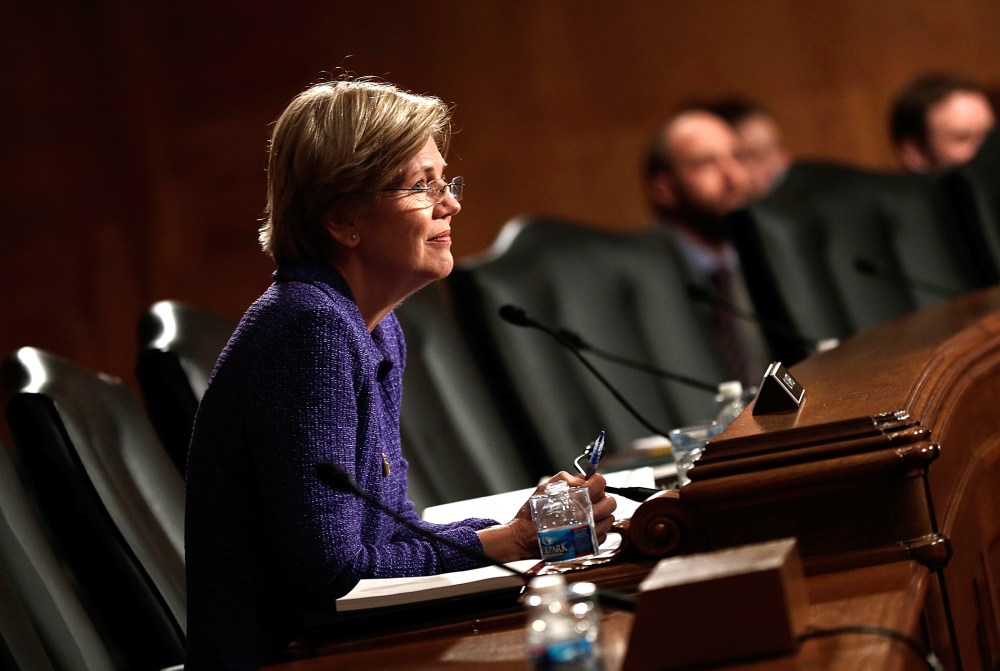 Sen. Elizabeth Warren (D-MA) listens as Consumer Financial Protection Bureau Director Richard Cordray testifies before the Senate Banking, Housing and Urban Affairs Committee, Nov. 12, 2013 in Washington, DC.