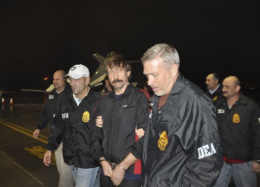 Suspected Russian arms dealer Viktor Bout (C) is escorted by Drug Enforcement Administration (DEA) officers after arriving at Westchester County Airport in White Plains, New York November 16, 2010. Bout maintained shell corporations in Delaware, taking...