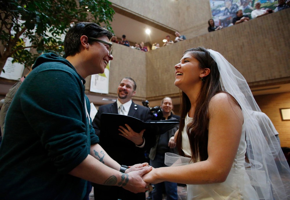 Jax Collins (L) and Heather Collins get married at the Salt Lake County Government Building in Salt Lake City, Utah, December 23, 2013.