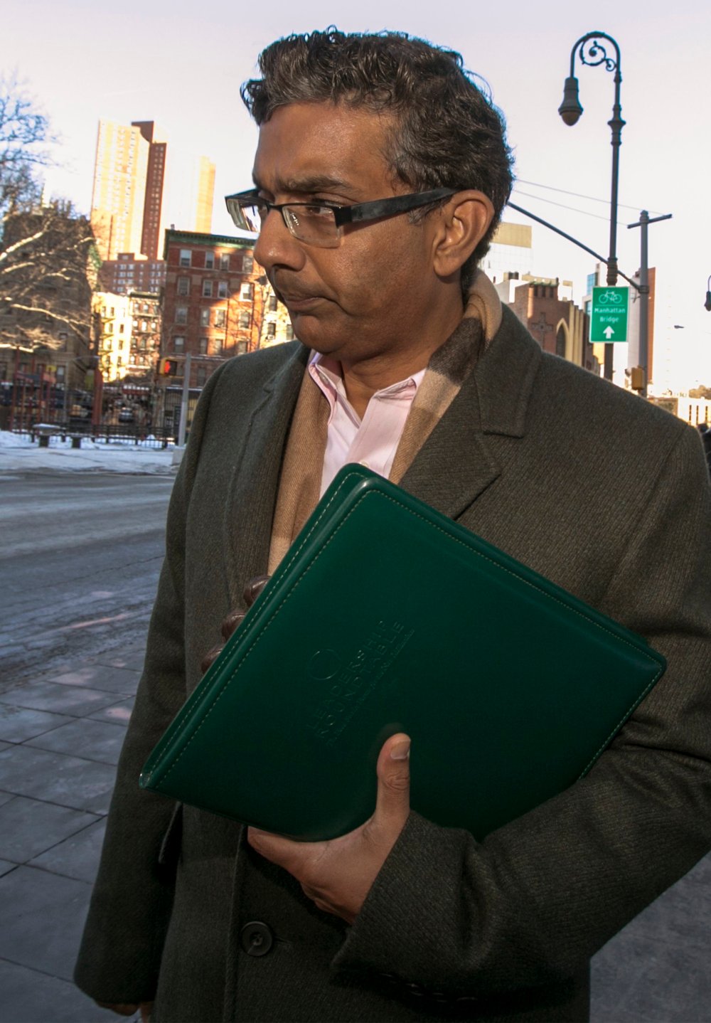 Conservative commentator, Dinesh D'Souza exits the Manhattan Federal Courthouse in New York, January 24, 2014.