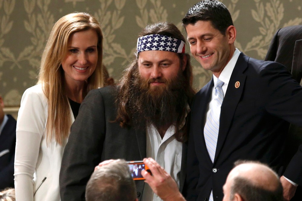 Duck Dynasty television show star Willie Robertson (C) and his wife Korie pose for a picture with U.S. Rep. Paul Ryan (R-WI) before the State of the Union speech at the U.S. Capitol in Washington Jan. 28, 2014.
