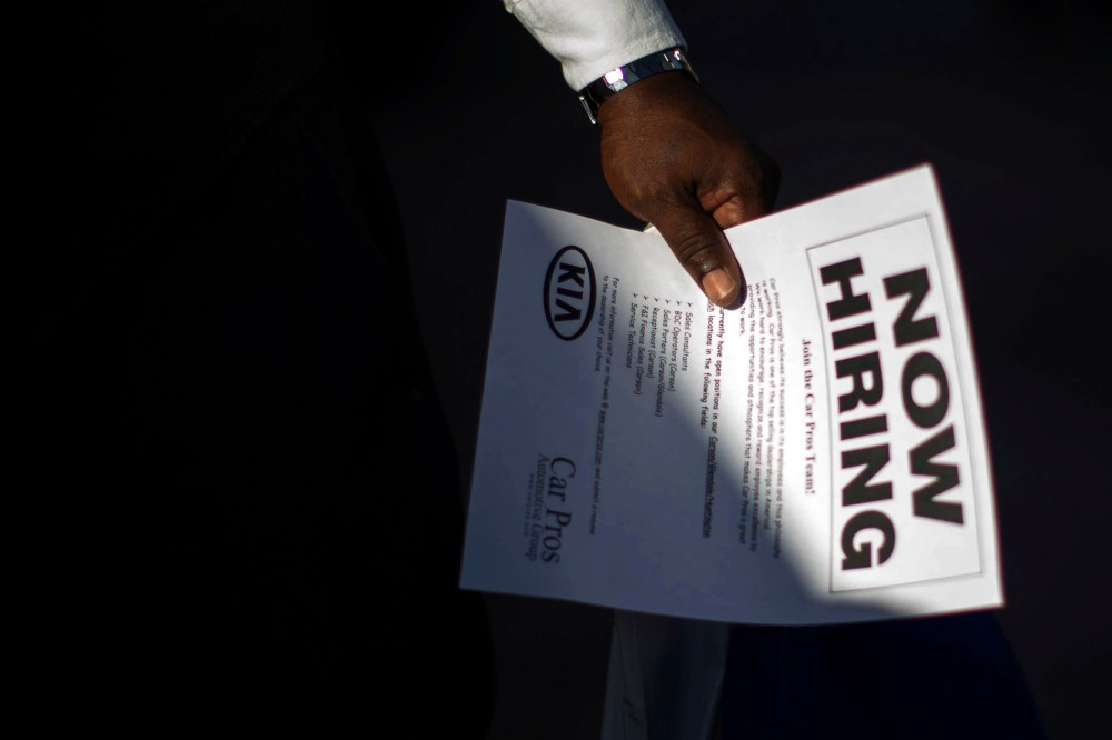 A man holds a leaflet at a military veterans' job fair in Carson, Calif. on Oct. 3, 2014.