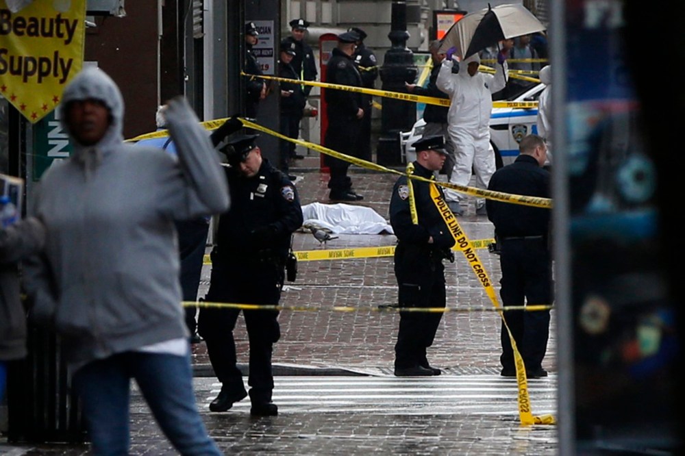 A body lays covered on Jamaica Avenue near 162nd street in the borough of Queens in New York on Oct. 23, 2014. (Shannon Stapleton/Reuters)