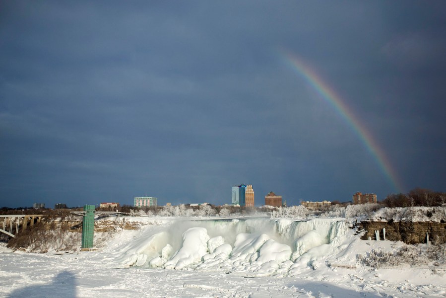 A rainbow appears over the partially frozen American Falls in sub freezing temperatures in Niagara Falls, Ontario on Feb. 17, 2015.
