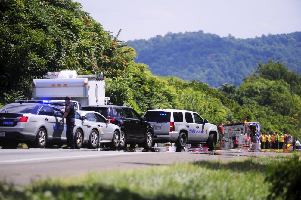 Police vehicles and ambulances are pictured near the car of suspected gunman Vester L. Flanagan, also known as Bryce Williams, (not pictured) off Highway I-66 in Fauquier County, Va., Aug. 26, 2015. (Photo by David Manning/Reuters)