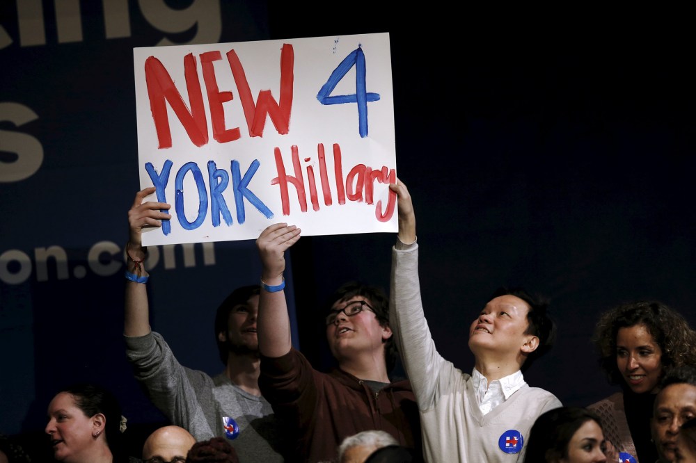 Supporters of Democratic presidential candidate Hillary Clinton hold a sign during a campaign rally at the Apollo Theater in New York, March 30, 2016. (Photo by Mike Segar/Reuters)
