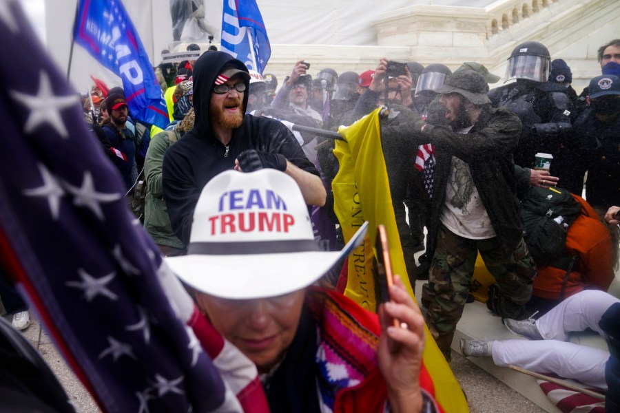 Image: Members of a pro-Trump mob try to break through a police barrier at the Capitol on Jan. 6, 2021.