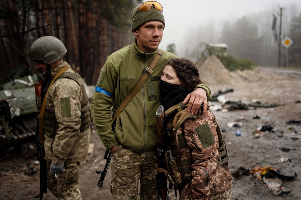 Ukrainian army soldier Igor, 23, embraces his wife Dasha, 22, after a military sweep to search for possible remnants of Russian troops after their withdrawal from villages in the outskirts of Kyiv on Friday, April 1.