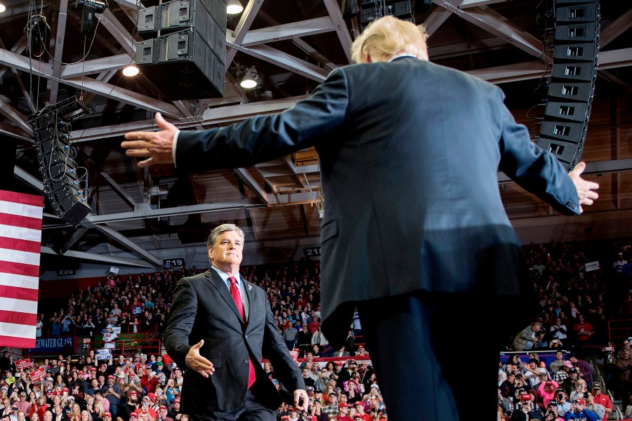 Donald Trump greets talk show host Sean Hannity at a Make America Great Again rally in Cape Girardeau, Miss. on November 5, 2018.