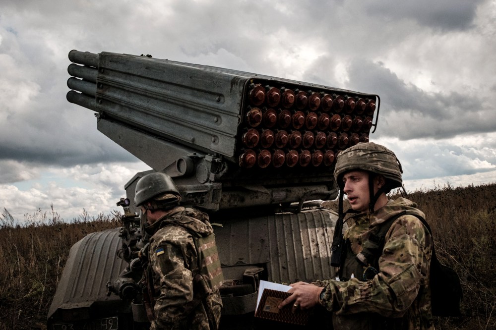 Image: Ukrainian soldiers prepare to fire a BM-21 multiple rocket launcher towards Russian positions in the Kharkiv region on Oct. 4, 2022.