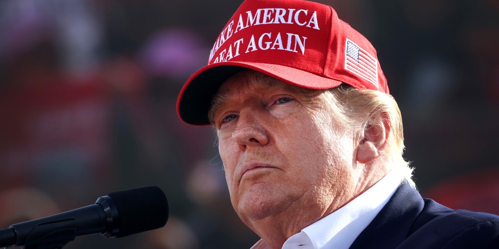 Image: Donald Trump wearing a red hat that reads,"Make America Great Again".