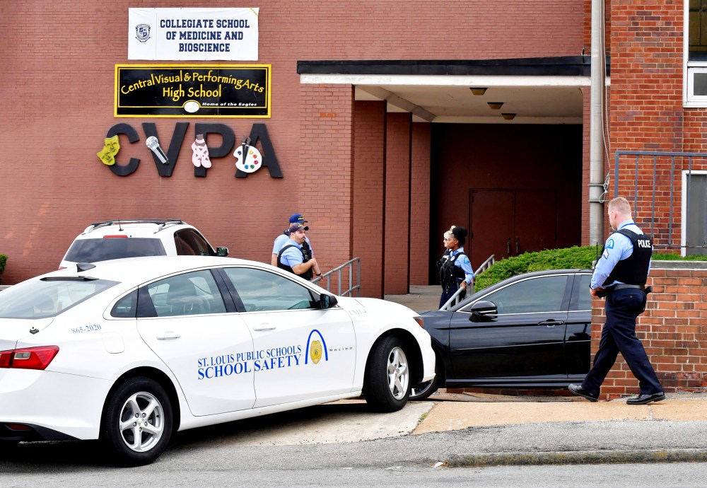 St. Louis metropolitan police officers stand outside an entrance at the northeast corner of the Central Visual and Performing Arts High School after a shooting that left three people dead including the shooter today in St Louis, Miss.