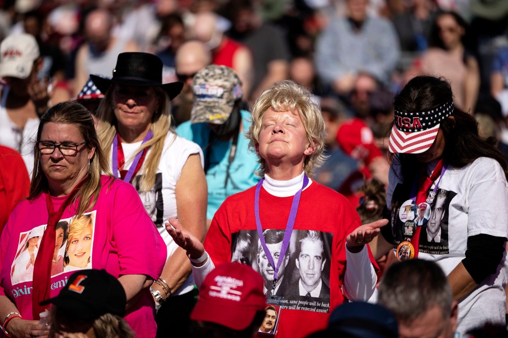 A crowd bows their heads in prayer during the invocation during a rally hosted by former President Donald Trump at the Delaware County Fairgrounds on April 23 in Delaware, Ohio.
