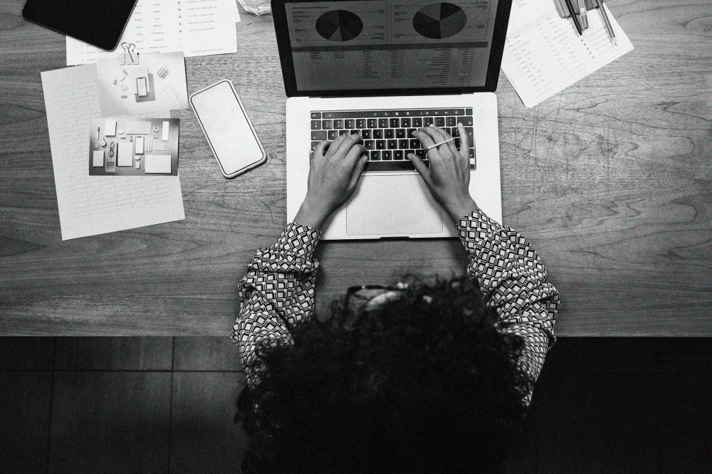 Overhead view of a Black woman working on a laptop