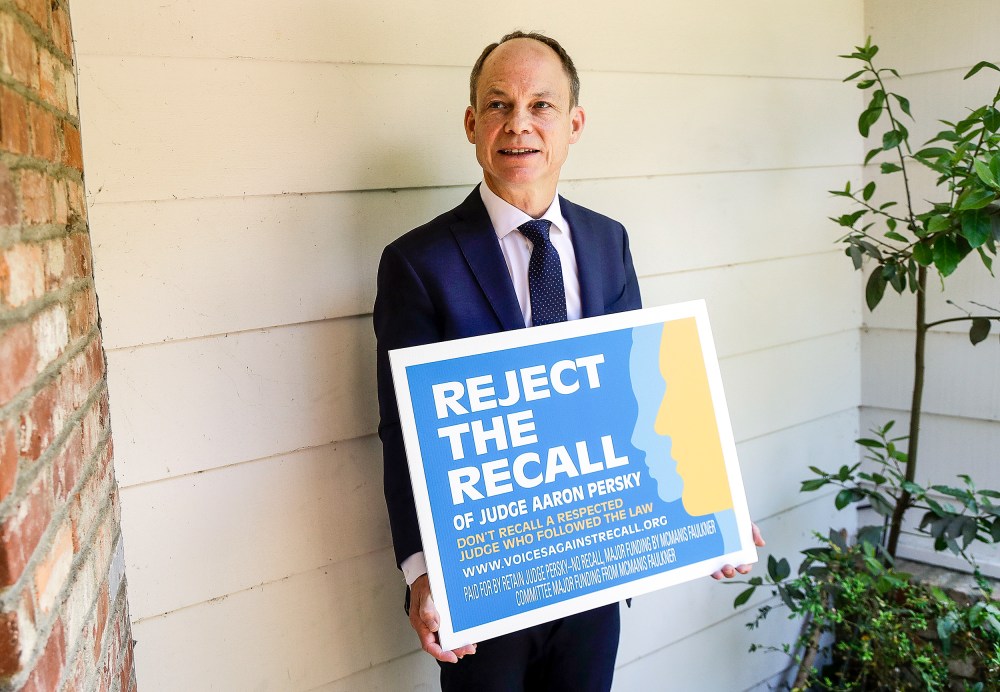 Judge Aaron Persky holds a sign opposing his recall in Los Altos Hills, Calif., on May 15, 2018.