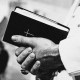 Man in popes garment holding holy bible
