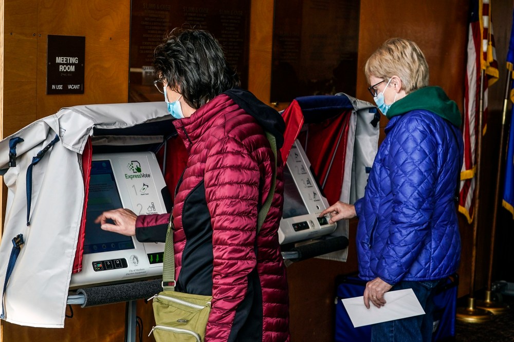 Image: Residents cast their votes at the Warner Park Community Recreation Center on the first day of early voting on March 21, 2023, in Madison, Wis.