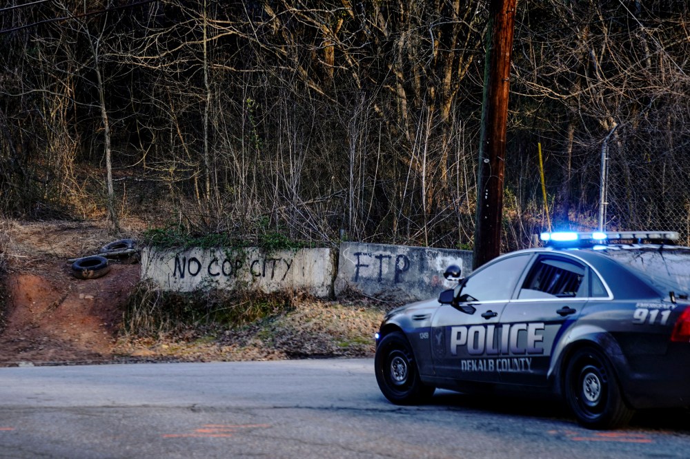 Law enforcement drive past the planned site of a police training facility that activists have nicknamed "Cop City" in Atlanta on Feb. 6, 2023.