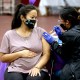 A woman receives a Pfizer vaccination booster shot in Los Angeles
