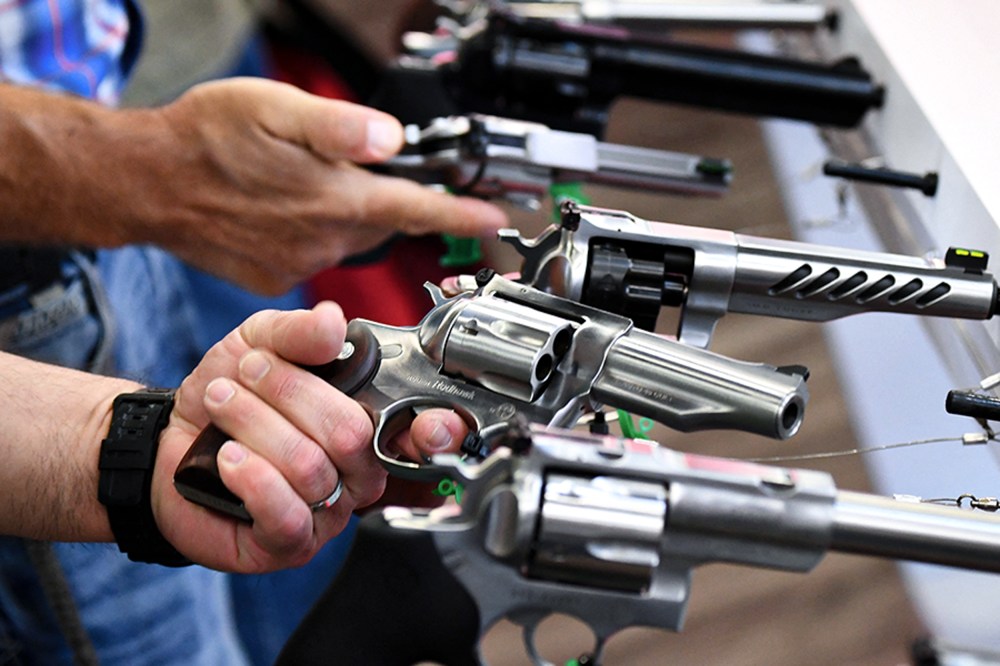 Attendees hold Ruger revolver pistols.