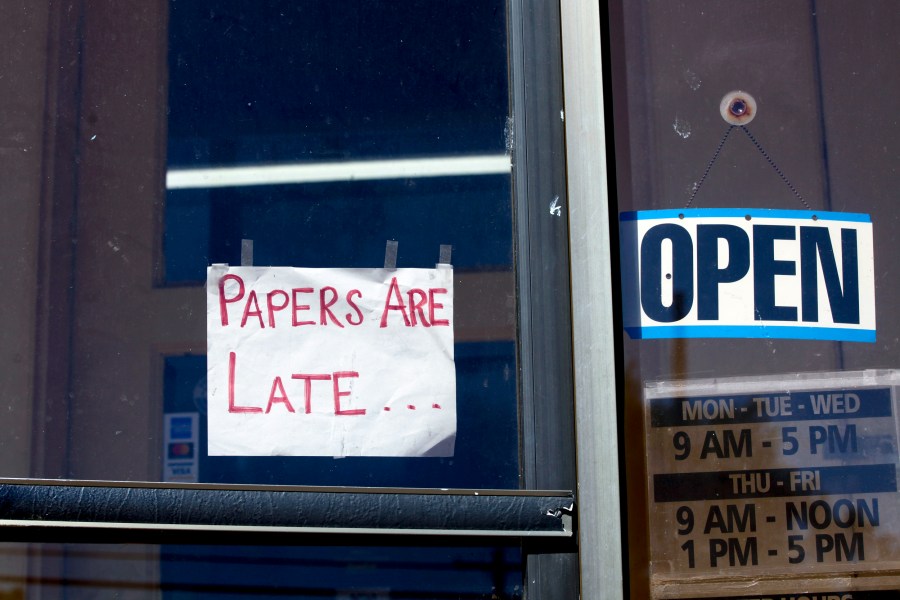 A handmade sign on a door of the Marion County Record that reads 