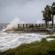 Waves impact a house seawall