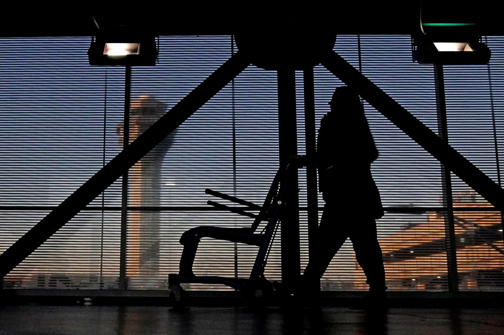 An airline employee transfers a wheelchair at O'Hare International Airport.