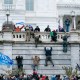 Trump supporters climb the west wall of the the Capitol