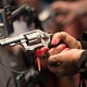 An attendee handles a Smith & Wesson pistol