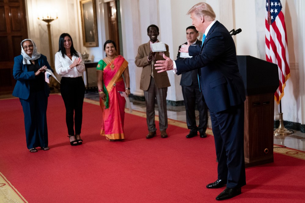 President Donald Trump greets attendees.