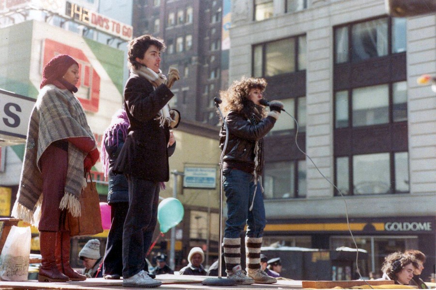 Maria Hinojosa speaking to a crowd, right.