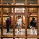 Visitors walk through a cell block of a prison