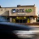 A car passes by Rite Aid store with a "Store Closing" sign.