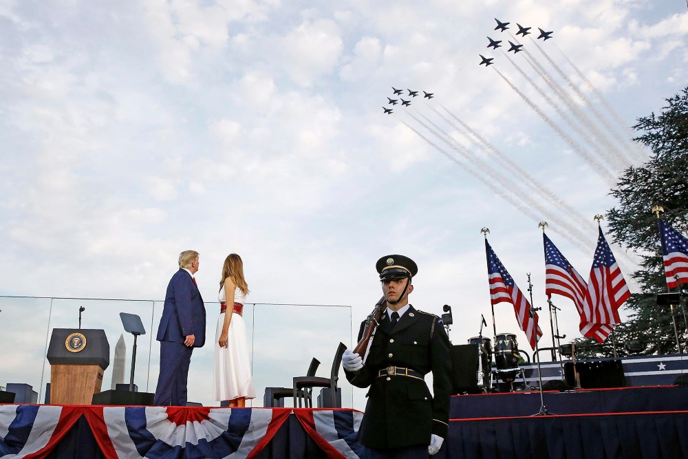 President Donald Trump and first lady Melania Trump watch as the U.S. Air Force Thunderbirds and U.S. Navy Blue Angels perform a flyover during a "Salute to America" event at the White House on July 4, 2020.