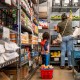 A child carries a basket of food at a food bank.